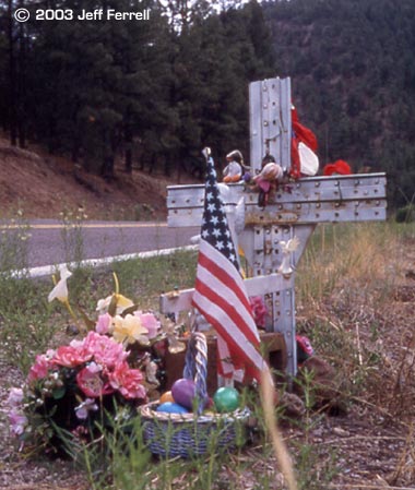 roadside shrine with american flag and flowers by jeff ferrell (paulsjusticepage.com)